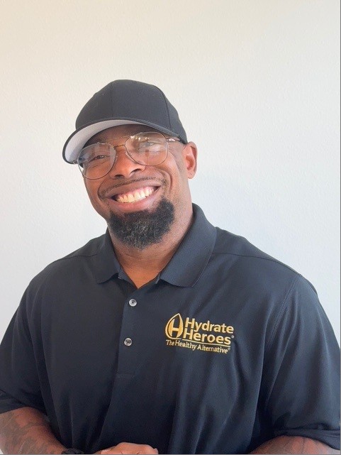 Jovon Quarles smiling in a black Hydrate Heroes polo